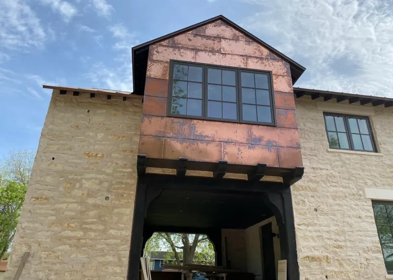 Copper metal panel facade on a stone building for Skylight Installation in Carrollwood