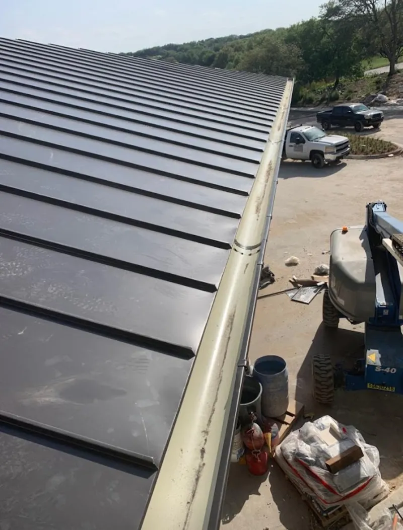Standing seam panel and gutter detail on a metal roofing jobsite in Carrollwood